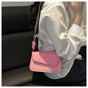 Pink crossbody bag with woven texture and wide checkered shoulder strap for women