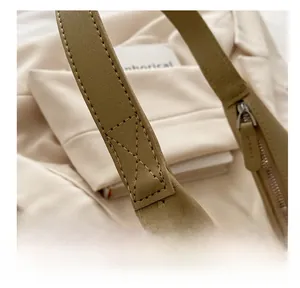 Detail shot of reinforced stitching and fine leather texture on stylish shoulder bag strap