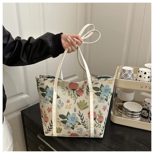 Close-up of floral jacquard tote bag with white leather straps and large capacity