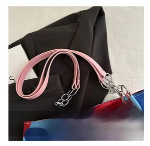 Detail of colorful geometric pattern on tote bag with pink strap and silver metal chain