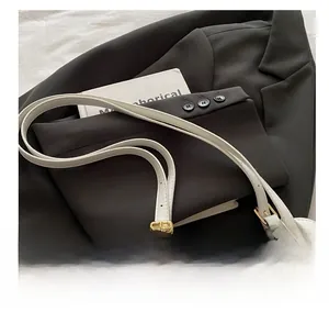Detail shot of linen canvas splicing and gold hardware buckle on a Boston handbag