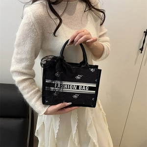 Elegant black floral tote bag with white rose embroidery and lace bow for women