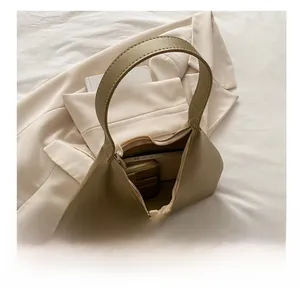 Interior view showing large capacity for wallet and phone in khaki faux leather shoulder bag