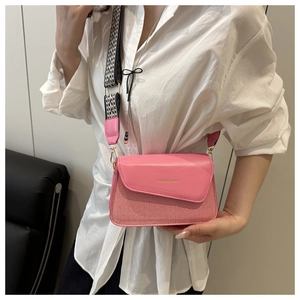 Detail of pink leather and fabric crossbody bag with trendy checkered wide strap