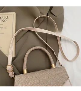 Detail of glitter champagne handbag featuring adjustable leather strap and gold hardware