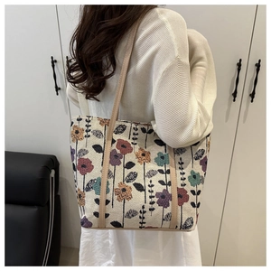 Detail of large floral tapestry tote bag featuring vintage jacquard fabric and long straps