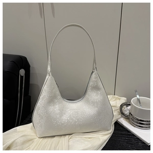 Detail of white snakeskin texture hobo bag with embossed logo in elegant setting
