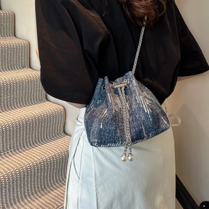 Blue denim bucket bag with silver sequins, chain strap and pearl drawstring closure
