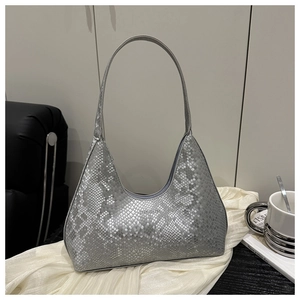 Detail of silver snake-pattern hobo bag with textured leather and metallic logo