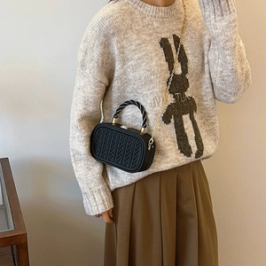 Chic black textured crossbody box bag with black-white spiral handle and gold chain strap