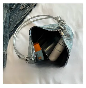 Internal capacity of light blue sequined denim shoulder bag showing spacious storage