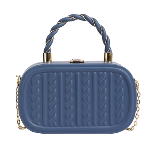Navy blue textured chain box bag with spiral handle and gold hardware in front view