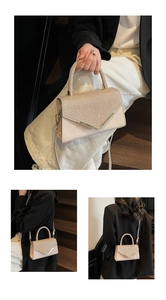 Detail view of the elegant beige handbag with glittering crystals and V-shaped metal trim