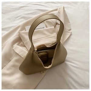 Detailed interior of khaki hobo bag showing spacious compartment and small matching pouch