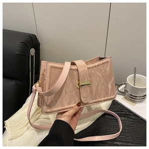 Detail of pink baguette bag with marble texture and gold square buckle in hand