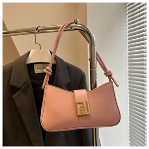 Pink matte leather baguette bag with large gold geometric buckle and knotted strap detail