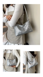 Detail of silver snake embossed underarm bag with decorative knotted shoulder strap