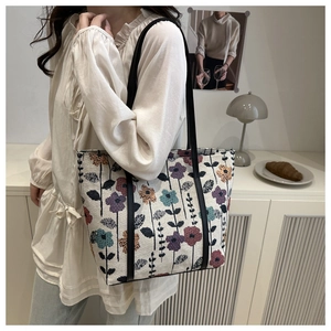 Close-up of vintage floral jacquard tote bag with elegant leather shoulder straps