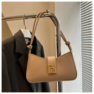 Close-up of beige PU baguette bag with golden FF buckle and knotted strap details