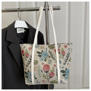 Detailed view of pastoral flower embroidery on large beige jacquard tote bag