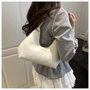 Detail view of cream white PU leather hobo bag with Fashion & Bags printed text