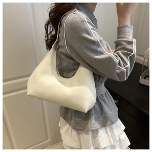 Close-up of white crescent shoulder bag with Fashion & Bags print on model side view