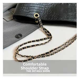 Detail of crocodile embossed faux leather with gold chain and leather shoulder strap