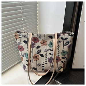 Detail of floral printed fabric tote bag with premium leather strap on a windowsill