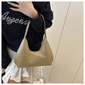 Detail of hobo bag in metallic gold finish with pearl-like luster and zipper closure