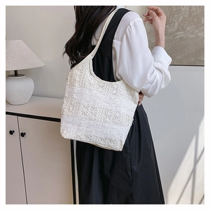 Gros plan détaillé du motif en crochet de dentelle blanche sur un sac fourre-tout chic