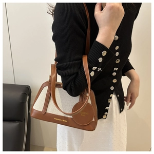 Woman carrying a vintage canvas and brown leather tote bag with FASHION & BAGS branding