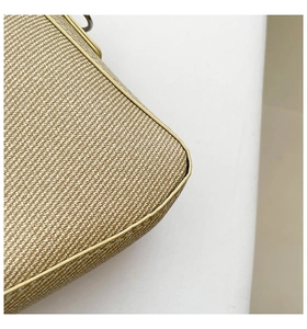 Close-up of woven straw texture and smooth yellow piping edge on the beige handbag