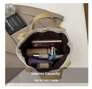 Detail view of large canvas tote bag showing internal capacity with multiple pockets