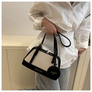 Close-up of canvas tote bag with black leather trim and Fashion & Bags gold lettering