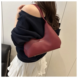 Detail of burgundy matte leather crescent bag with white Fashion & Bags lettering print