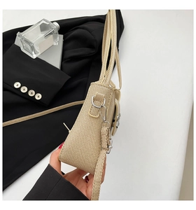 Side profile of beige woven texture shoulder bag with silver hardware and dual straps