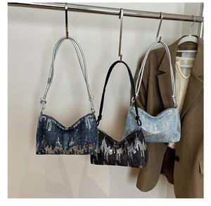 Close-up of three Y2K style sequin shoulder bags in black, dark blue and light blue