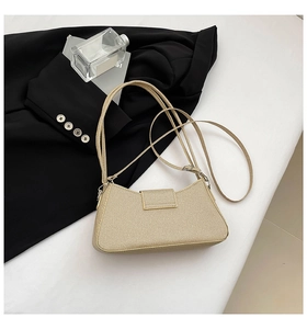 Close-up of beige shoulder bag with twill texture and adjustable strap in trendy setup