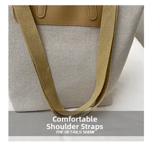 Detail showing comfortable wide fabric shoulder strap and khaki leather stitching on tote bag