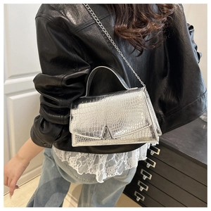 Silver crocodile textured handbag featuring a metal V-clasp and elegant chain strap