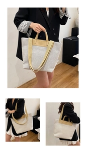 Detail of large canvas tote bag showing yellow leather handles and linen texture details