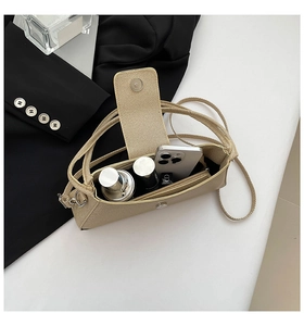 Detail view of beige crossbody bag interior showing spacious pockets with daily essentials