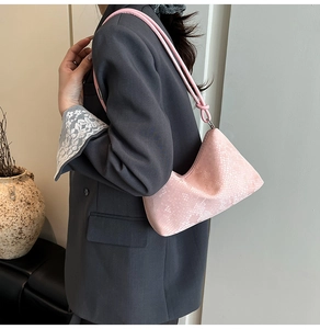Pink snakeskin pattern shoulder bag with a unique geometric design and knotted strap