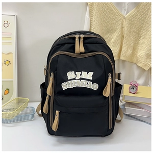 Detailed close-up of nylon backpack showing front pocket, logo, and side bottle holders