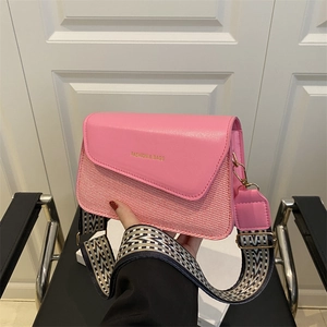 Pink minimalist crossbody bag with textured patchwork and jacquard strap display
