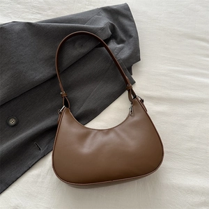 Detailed top view of a brown matte leather half-moon bag with silver hardware accessories