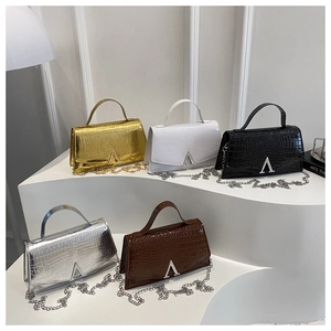 Detailed display of five crocodile pattern leather handbags in various elegant colors
