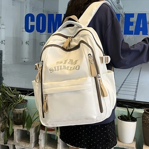 Minimalist cream nylon backpack with brown straps for students and daily commuting
