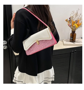Detail of color-block bag with white leather, pink sequins and golden clasp