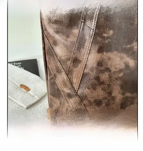 Detailed close-up of retro brown tote bag featuring high-quality cross stitching and texture